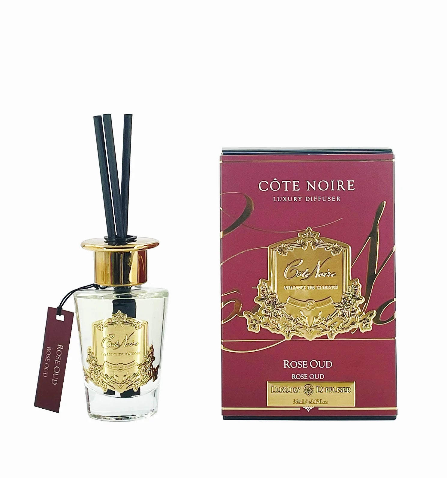 schwarze duftstaebchen im glas mit goldenem deckel und emblem. dunkelrote verpackung. rose oud 90ml.