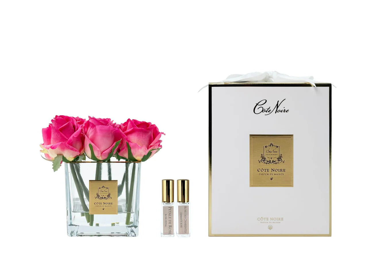 Luxuriöse Duftblume mit vier magentafarbenen Rosen in eckigem Glasgefäß mit goldener Etikette und eleganter Geschenkbox – inkl. Parfumflakons