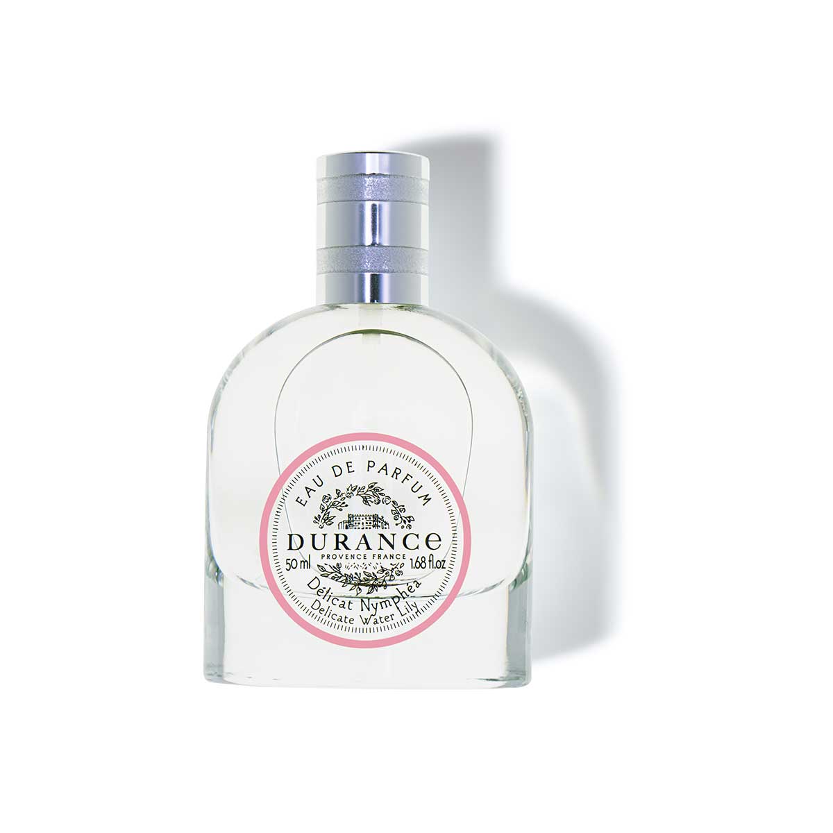 edp zarte seerose in einer halbrunden glasflasche zum spruehen. hintergrund weiss
