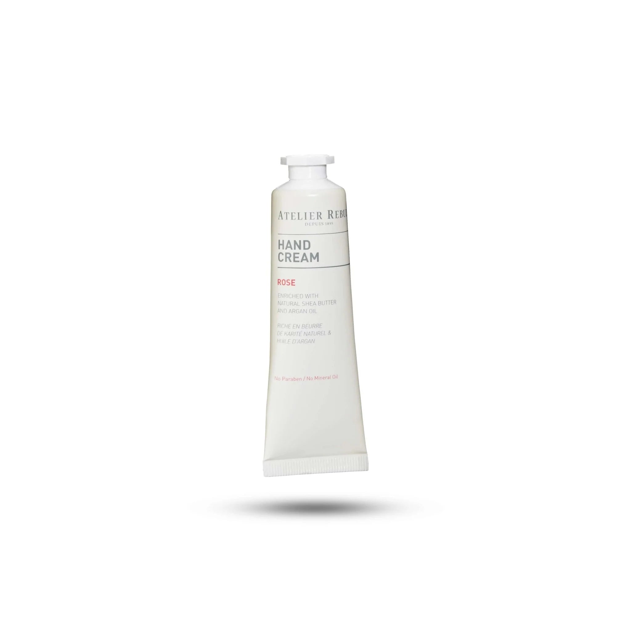 hinter weissem hintergrund schwebt die weise atelier rebul handcream mit schraubverschluss