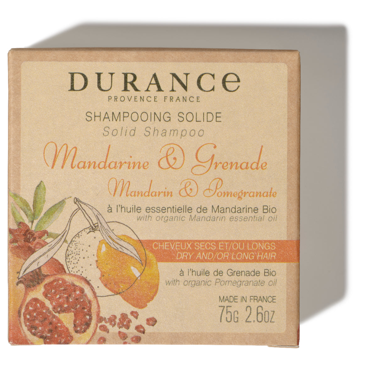 viereckiges festes shampoo in papier verpackung mit mandarine und granatapfel aufschrift.
