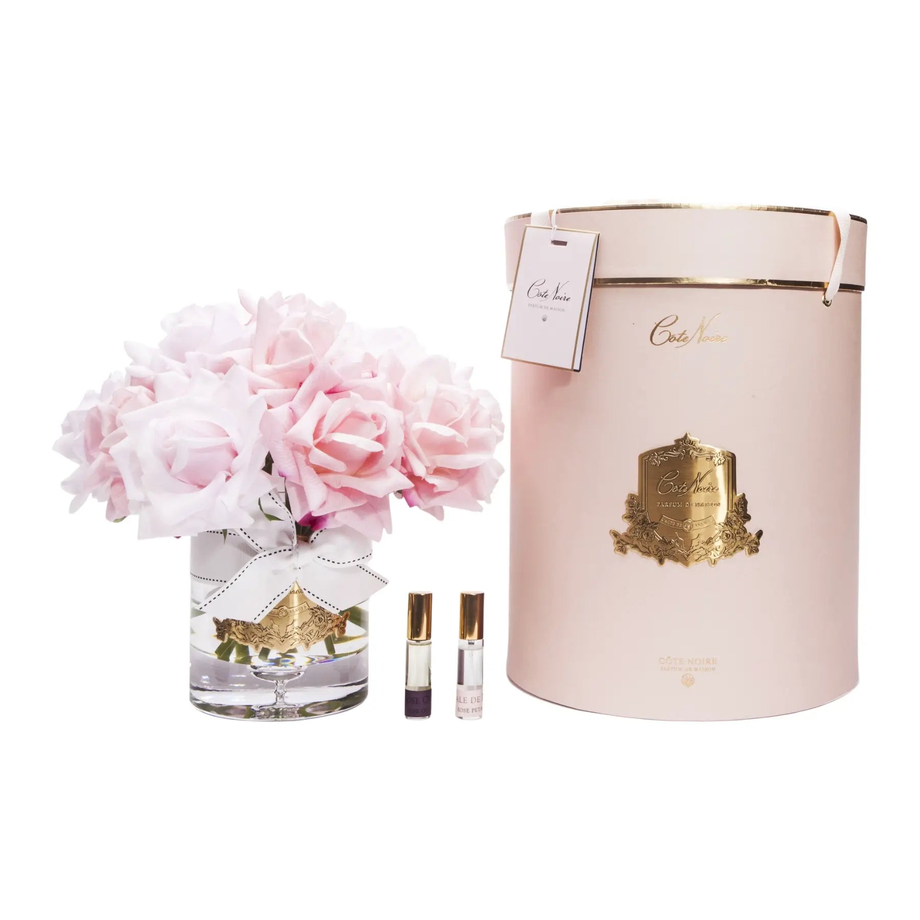 Duftende Rosen in abgestuften Rosatönen mit goldfarbenem Emblem – luxuriös verpackt in zartem Rosé.