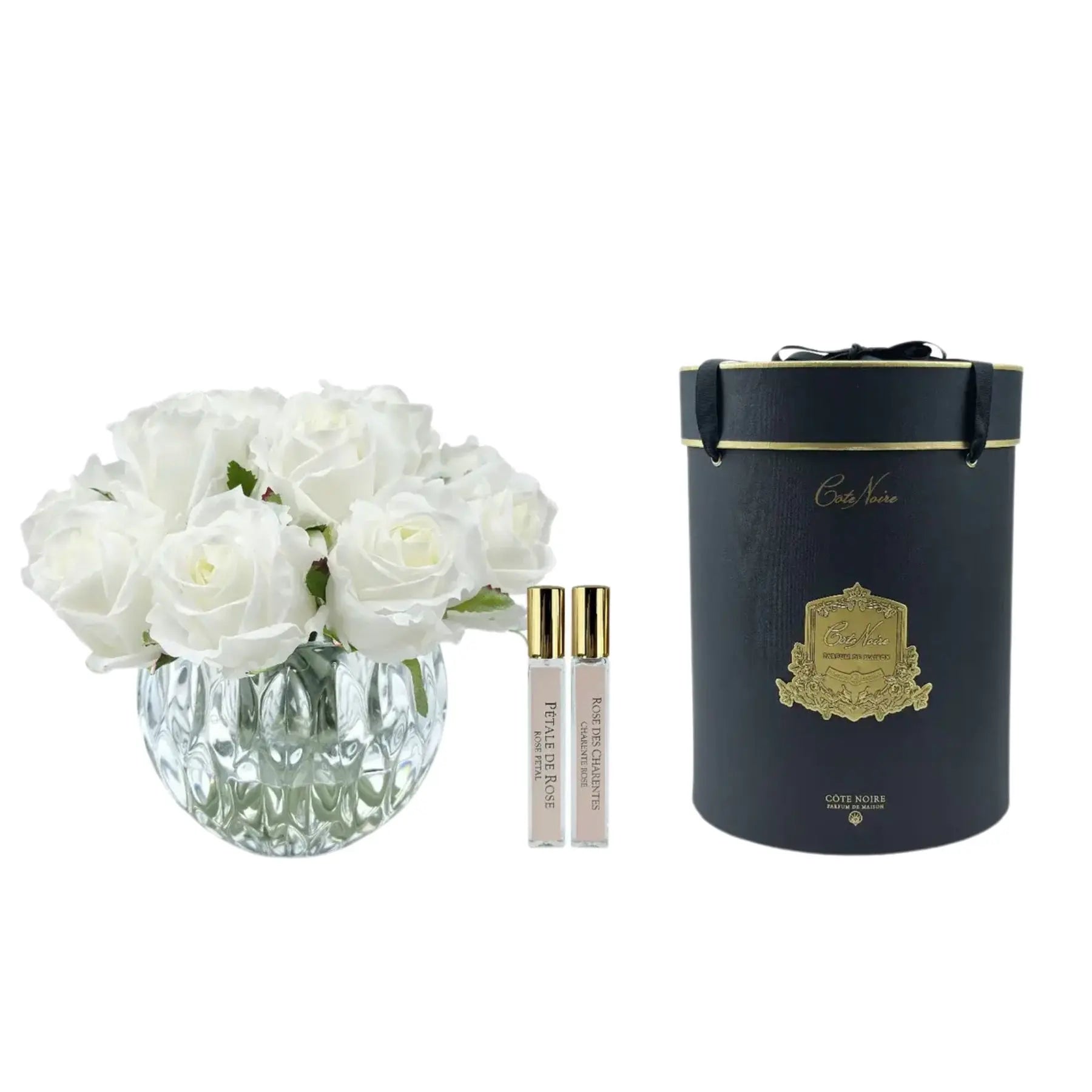 Weiße Duftrosen in runder Glasvase mit zwei Parfum-Sprays und eleganter Geschenkbox – luxuriöses Raumaccessoire mit französischem Stil
