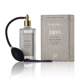 1895 parfum 125ml glasflasche mit pumpspray neben der beigen verpackung.