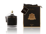 cote noire grand art duftkerze in dekorativem glas, daneben verpackung mit geschenkschleife, schwarz und gold.