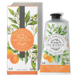 silberne mit orangen bedruckte schraubtube daneben die dazugehoerige verpackung vor weissem hintergrund