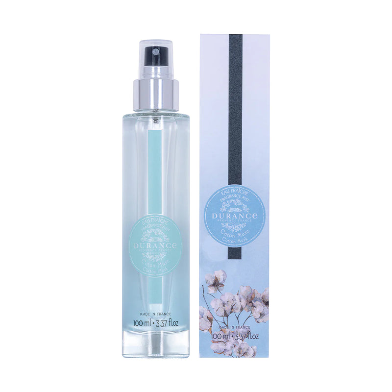 durchsichtige runde glasflasche eau fraiche baumwoll moschus mit silbernen spruehkopf und verpackung vor weissem hintergrund